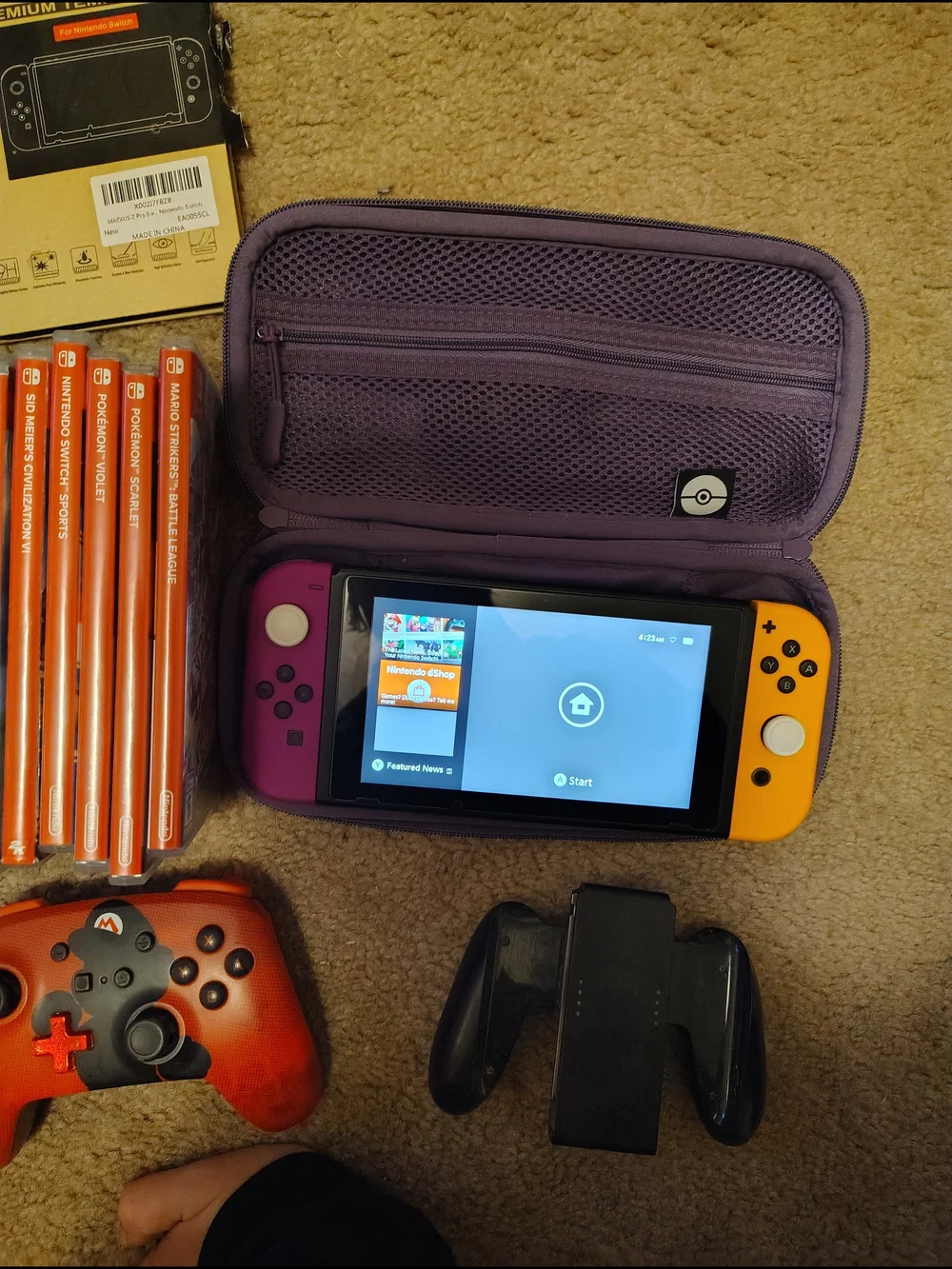 Nintendo handheld with Purple Carry Case and Yellow/Purple Joy‑Con
